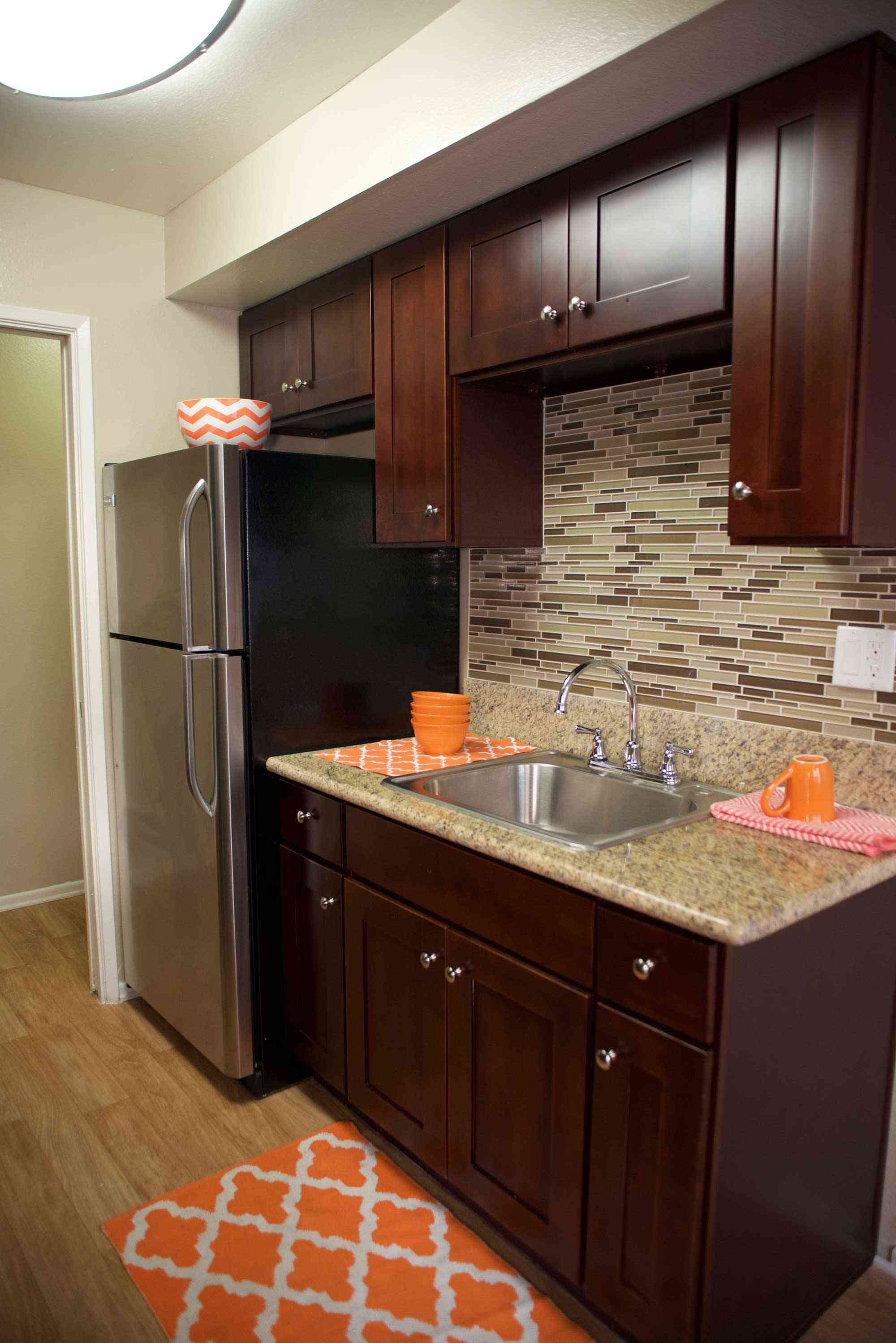 lime on 4th apartments modern kitchen with dark wood cabinets and granite countertops