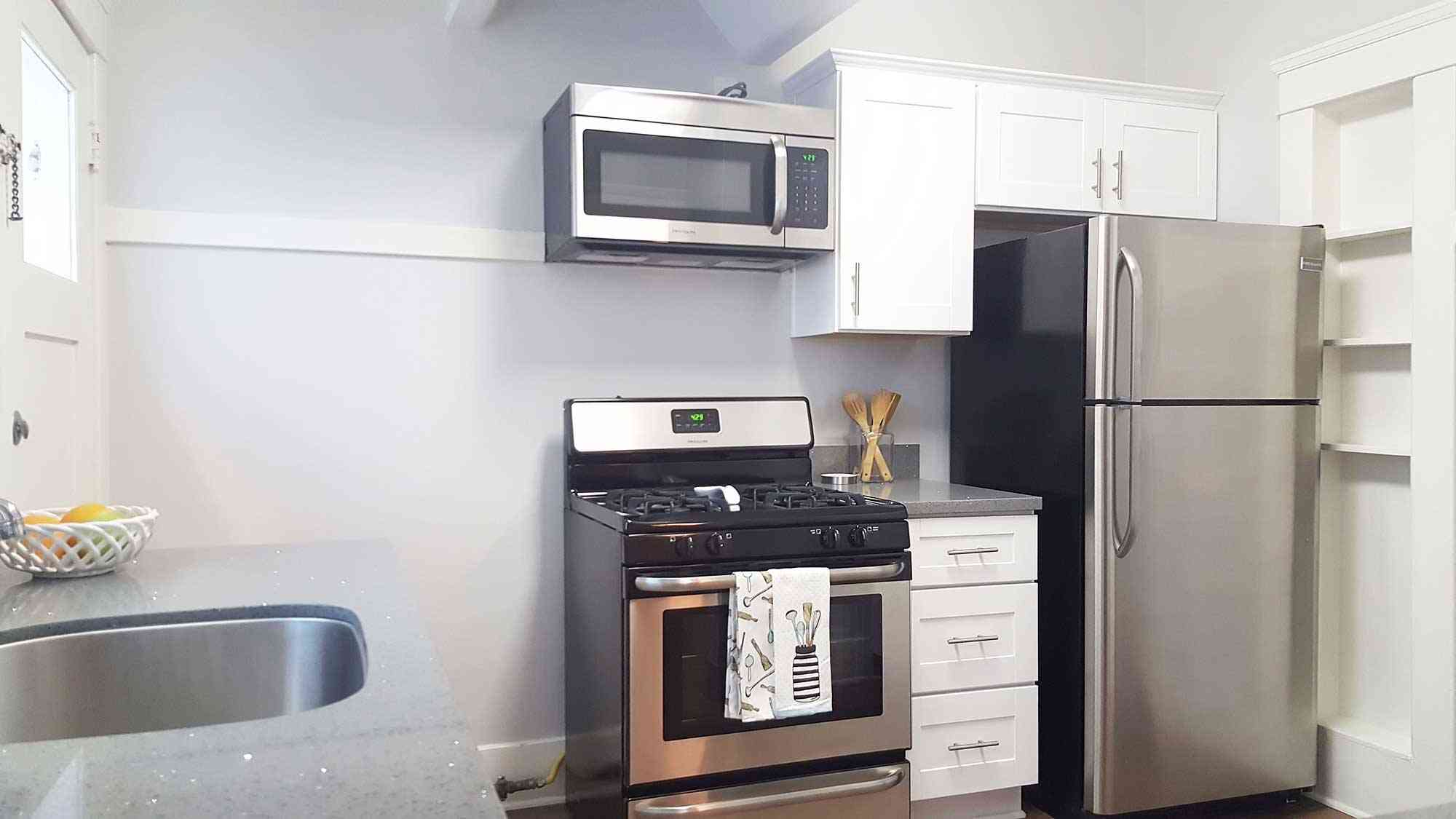 seaglass apartments modern kitchen with stainless steel appliances and white cabinets