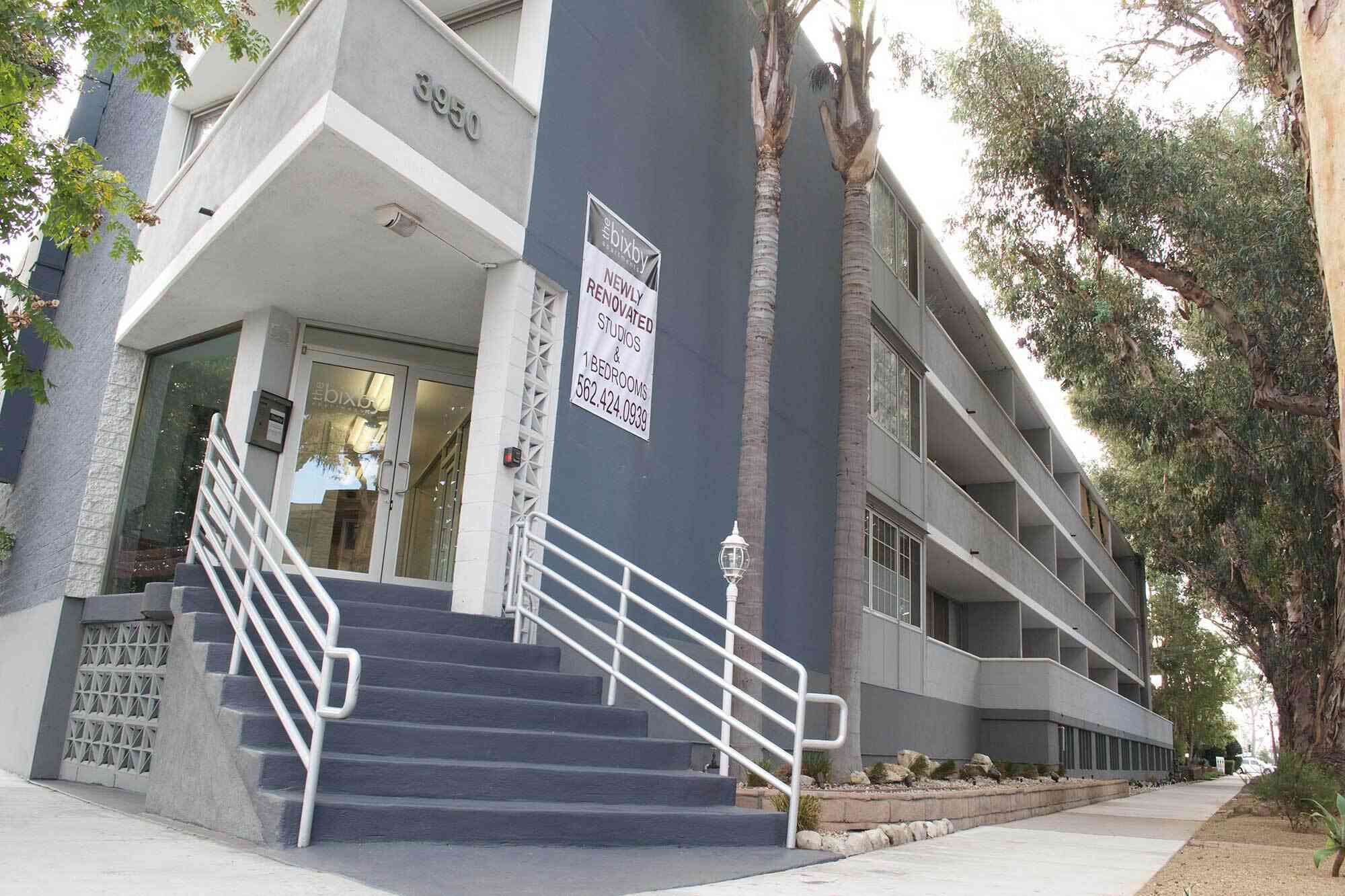 the bixby apartments exterior building leasing entrance with concrete steps
