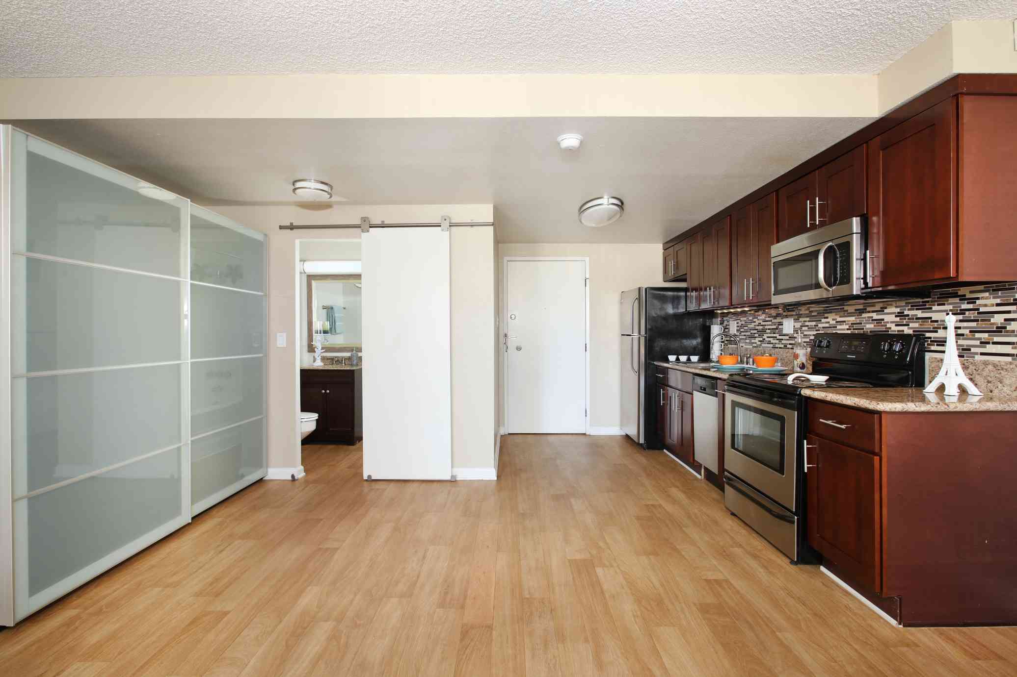 the bixby apartments open studio floor plan showing kitchen and sliding barn door