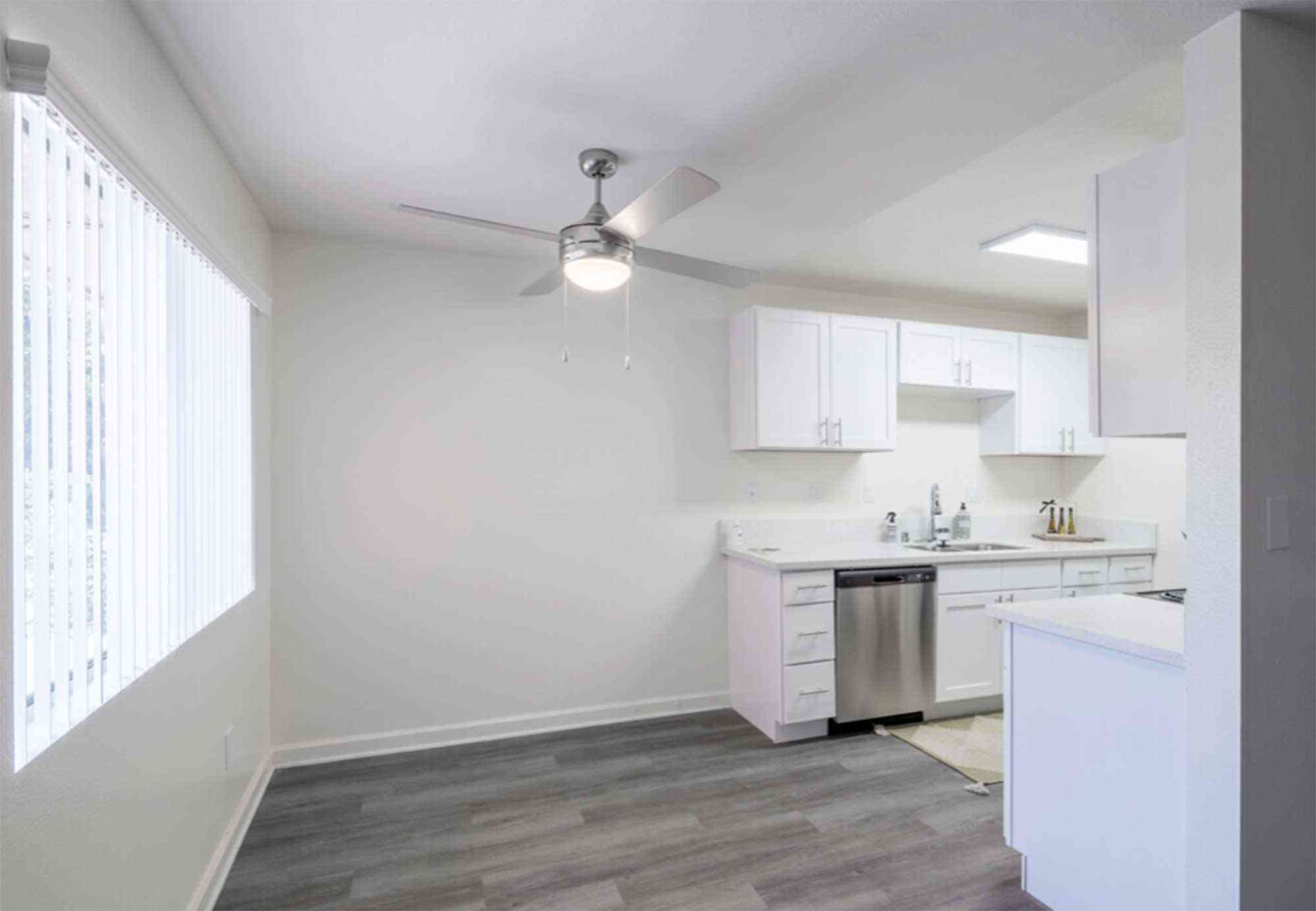 knolls on elm apartments dining area with ceiling fan and hardwood style flooring