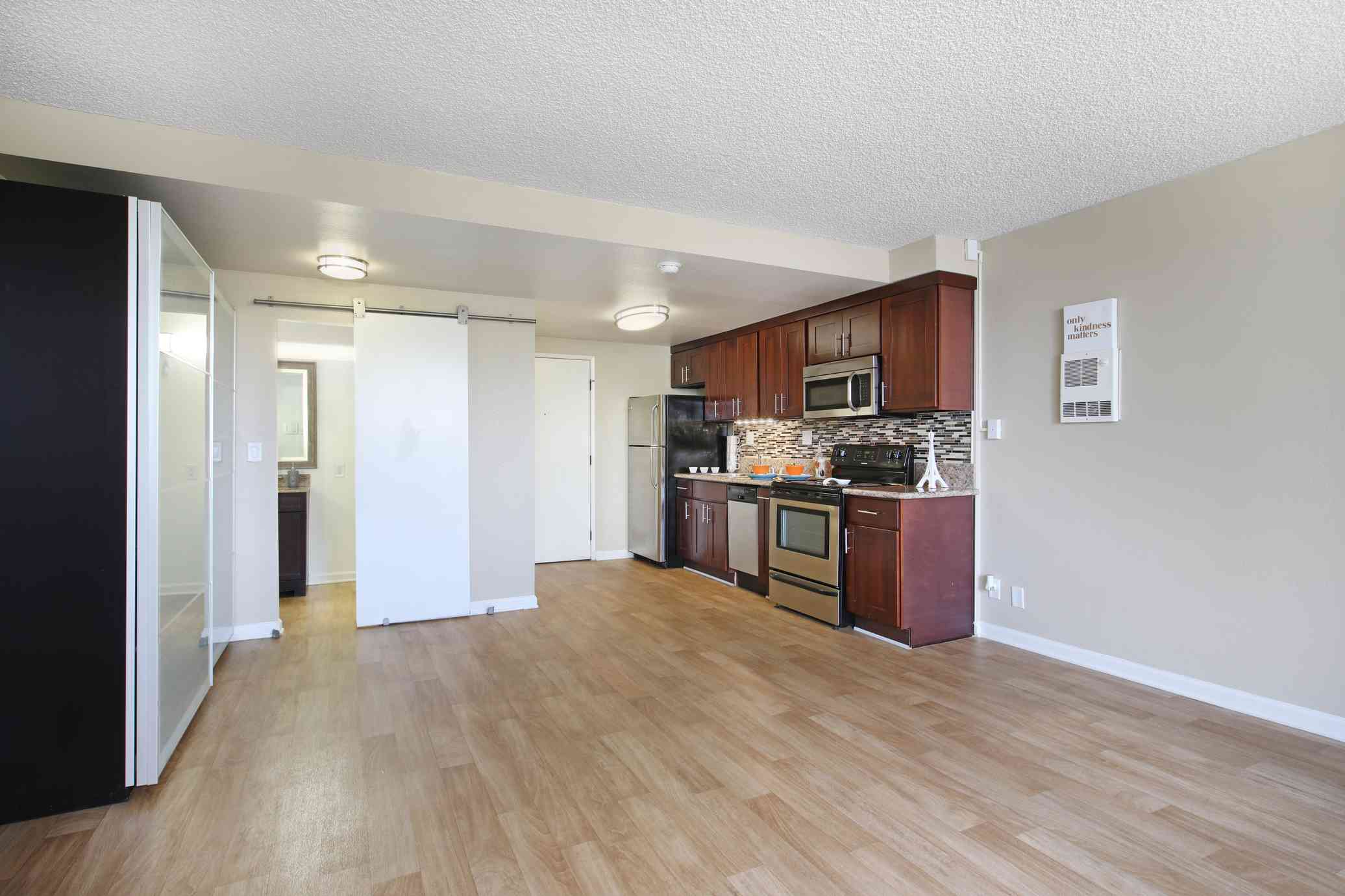 the bixby apartments spacious studio apartment interior with hardwood style flooring