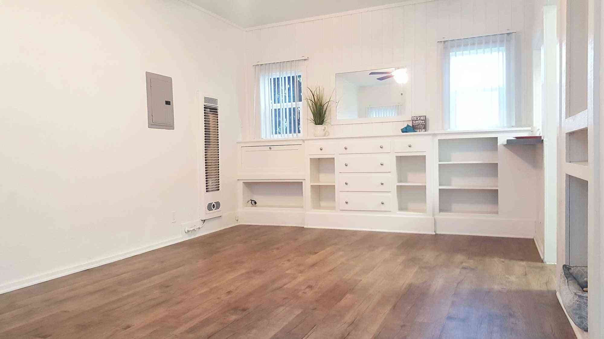 seaglass apartments living room featuring built in shelving and drawers