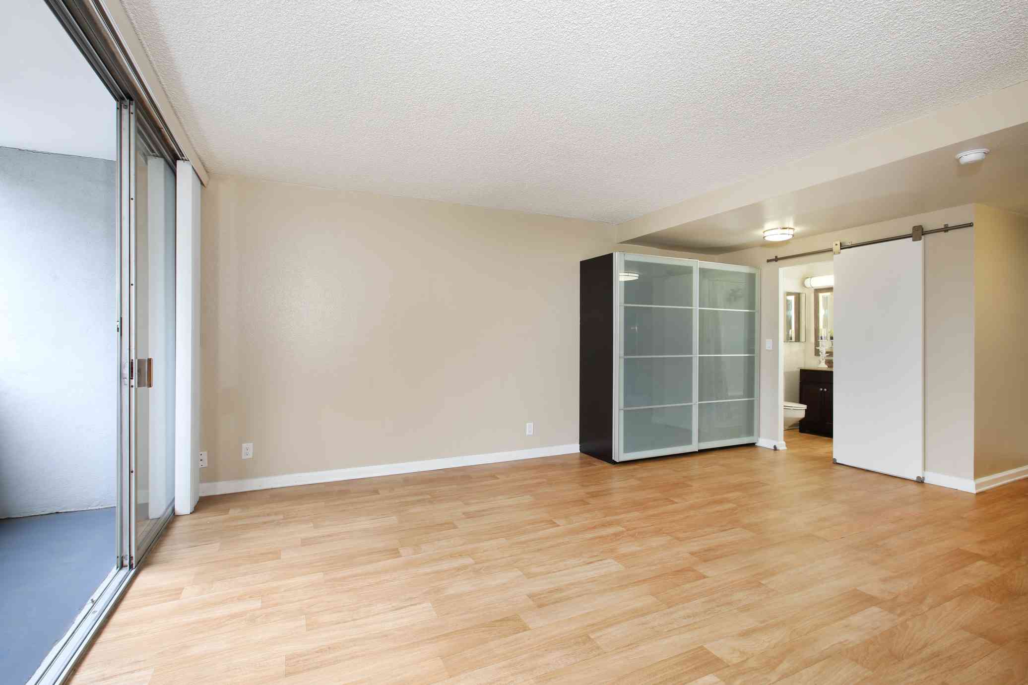 the bixby apartments unfurnished studio living area with sliding glass patio door