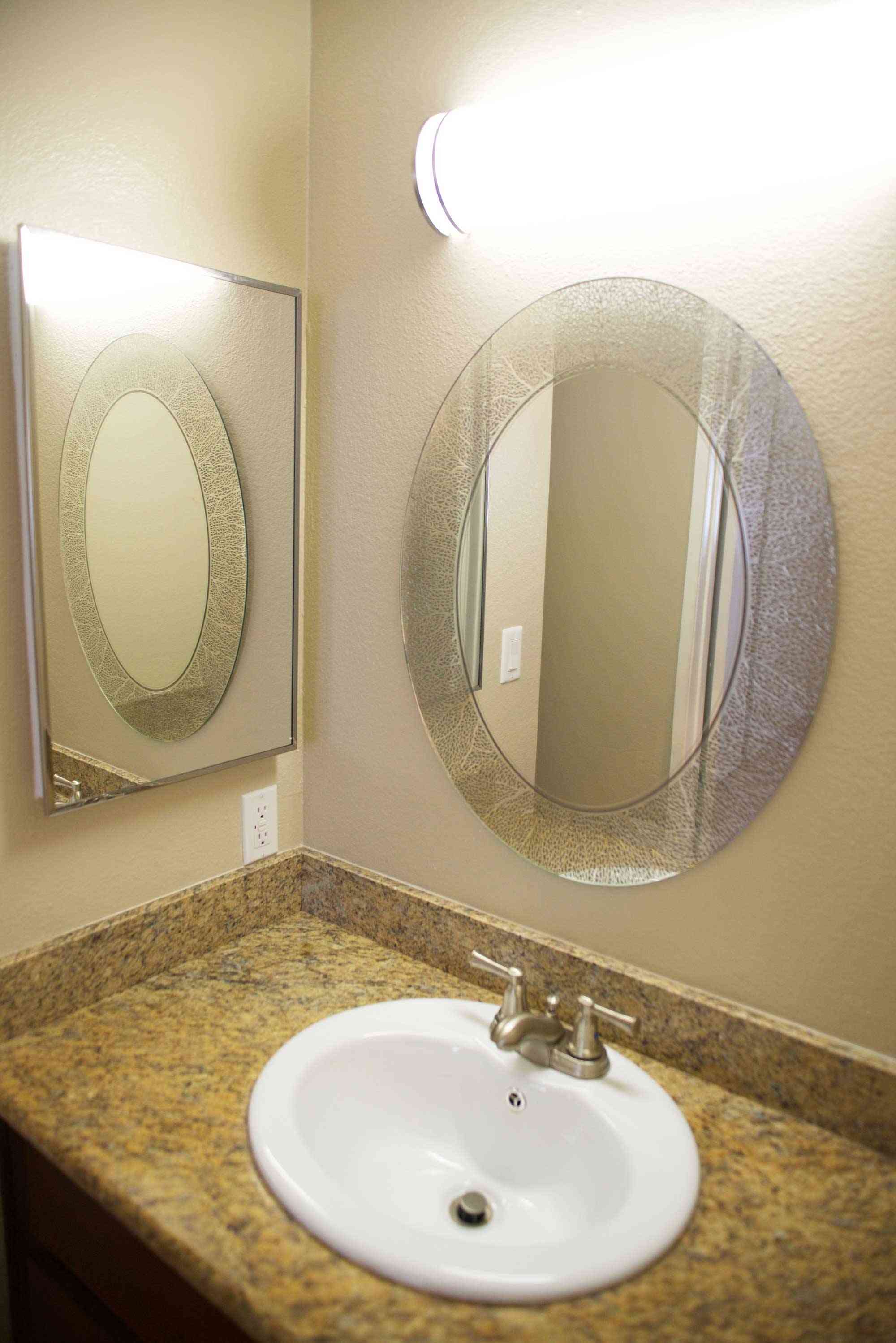 lime on 4th apartments bathroom vanity with granite countertop and mirrors