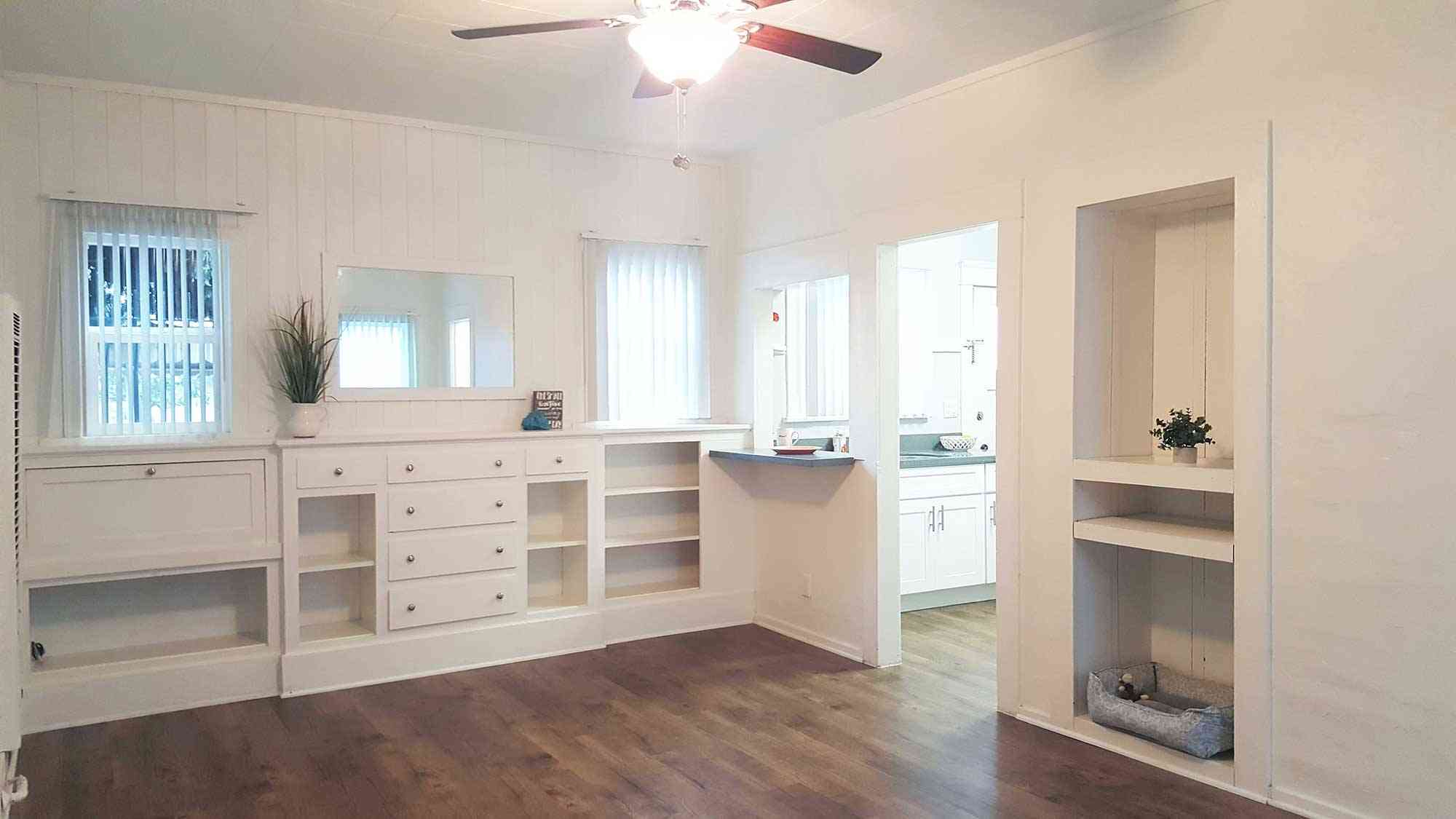 seaglass apartments spacious living room with ceiling fan and built in storage