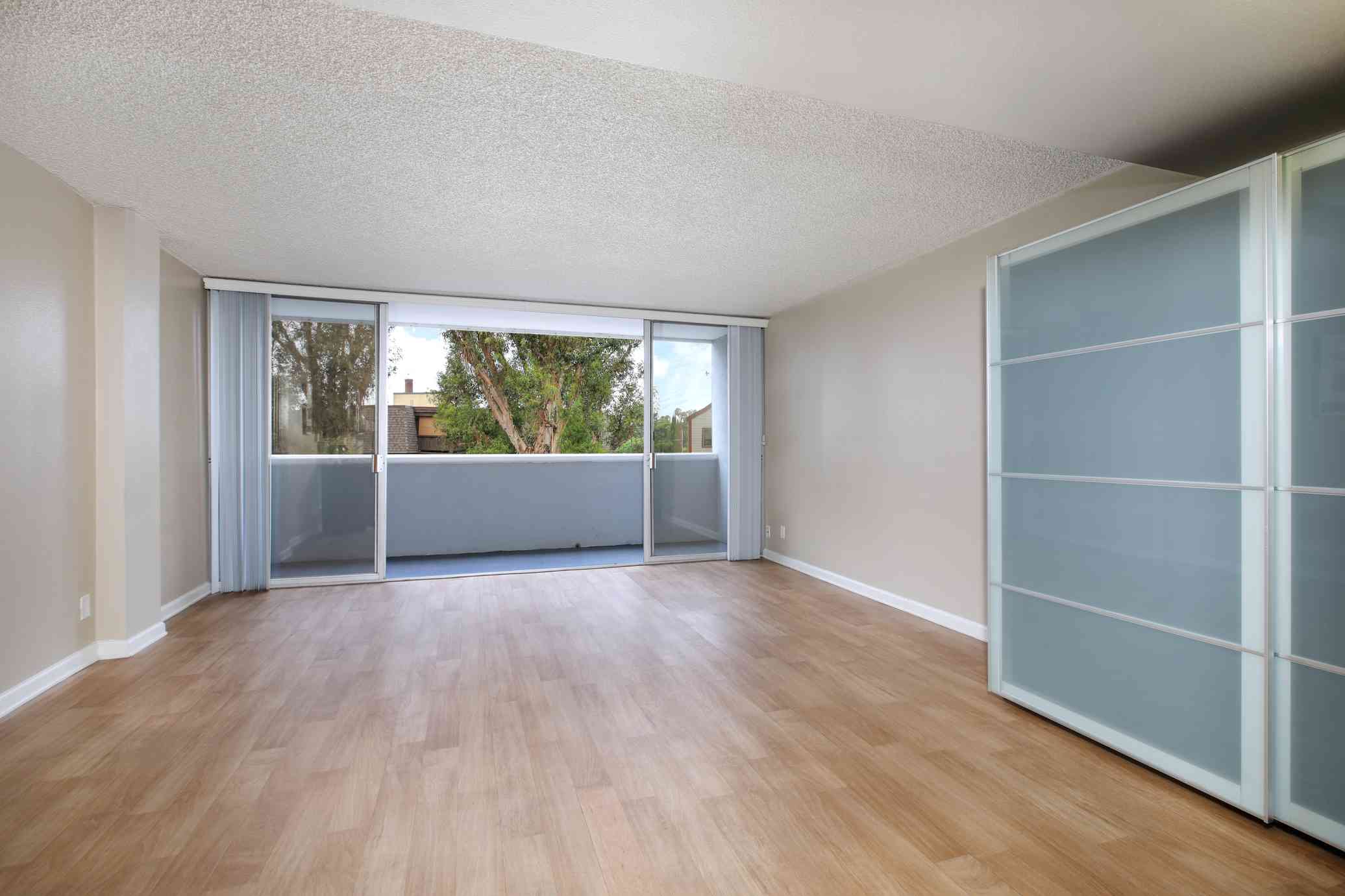 the bixby apartments studio living area with sliding glass balcony door