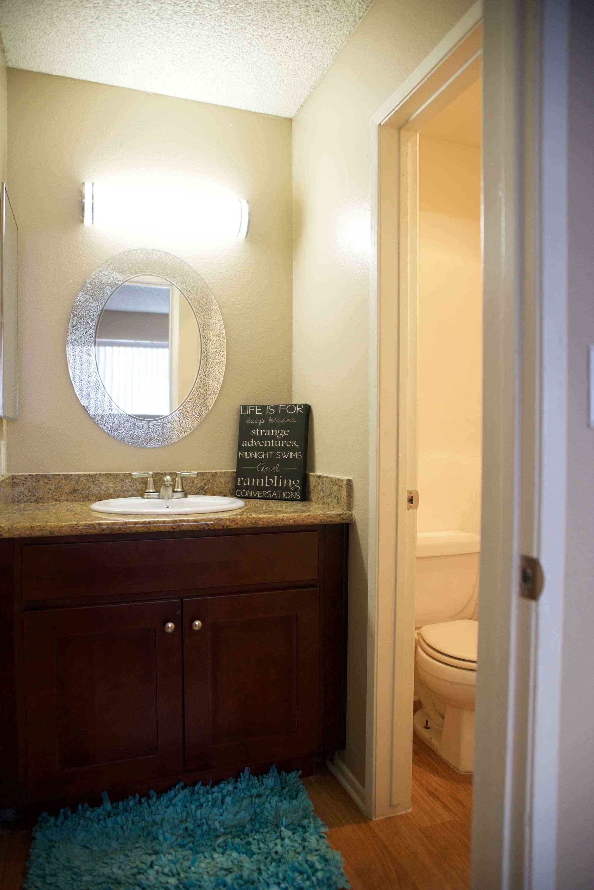 lime on 4th apartments bathroom interior with dark wood vanity