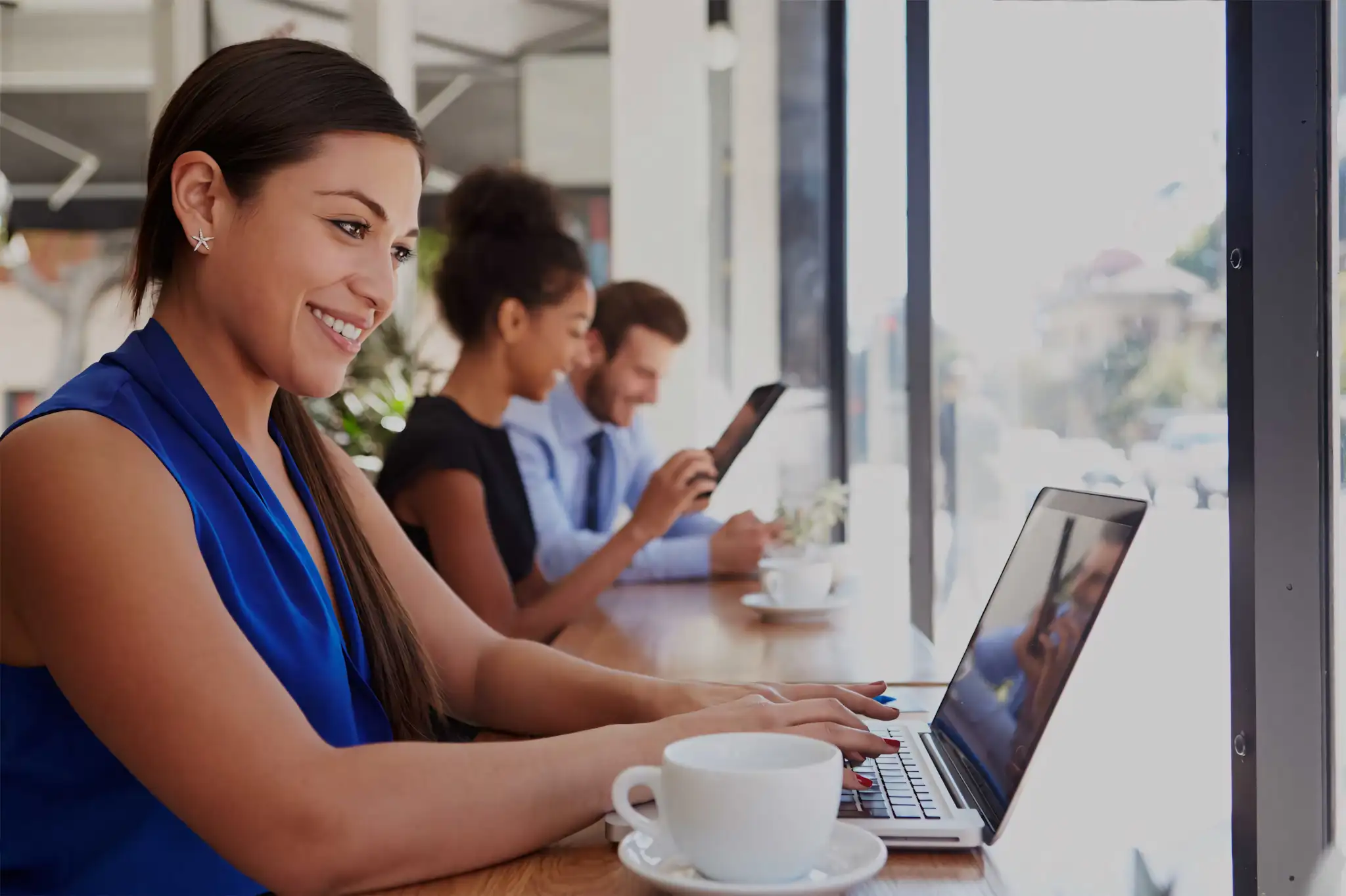 Elm Court woman on laptop at coffee shop